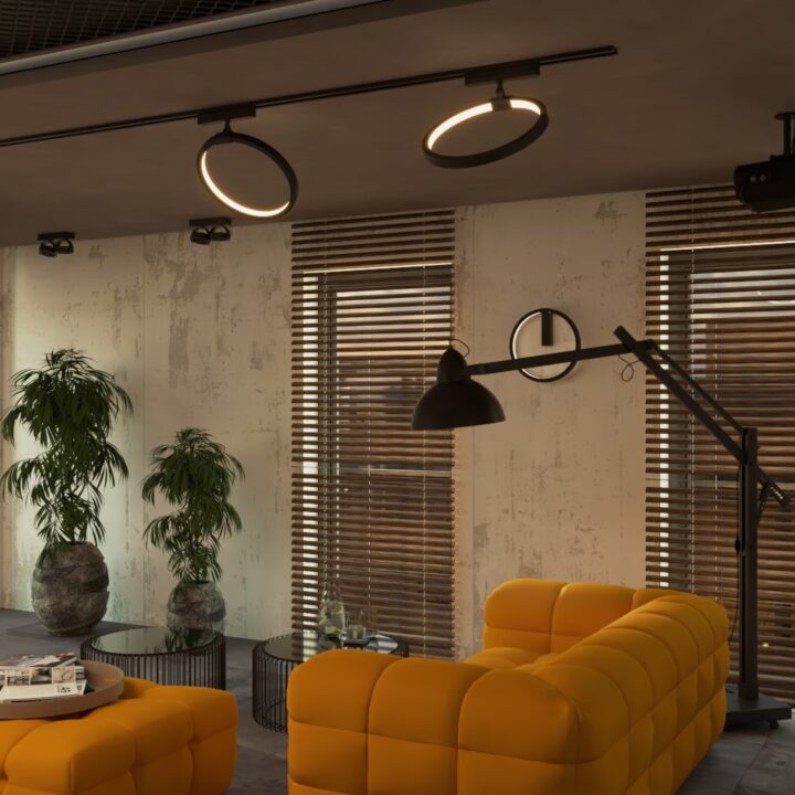 Salon jest utrzymany w industrialnym stylu, z jasnymi ścianami. Duża kanapa w intensywnym żółtym kolorze stanowi wspaniałe akcentowe miejsce do relaksu i odpoczynku. W salonie znajduje się również projektor, który umożliwia oglądanie filmów i ulubionych programów. Cała przestrzeń jest dobrze oświetlona dzięki dużym, panoramicznym oknom, które wpuszczają obfite ilości naturalnego światła, dodając uczucie przestronności i lekkości. Dodatkowo, kuchnia i salon są odpowiednio oświetlone nowoczesnymi lampami sufitowymi, aby zapewnić odpowiednie oświetlenie w każdej części pomieszczenia.